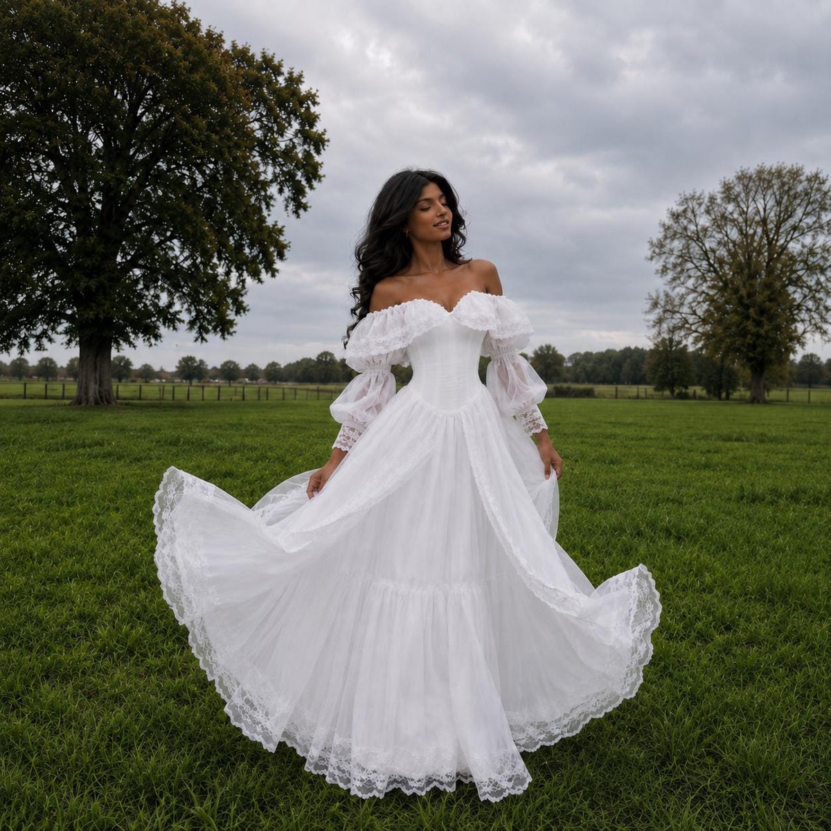 May include: A floor-length white dress featuring an off-the-shoulder neckline, voluminous sheer puff sleeves with lace trim, and a full, flowing skirt with a tiered lace-edged hemline. The bodice is fitted, and the fabric has a sheer, layered texture.